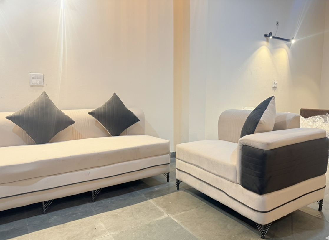Modern living room with beige sofa and armchair featuring gray cushions along with 4 puffs.